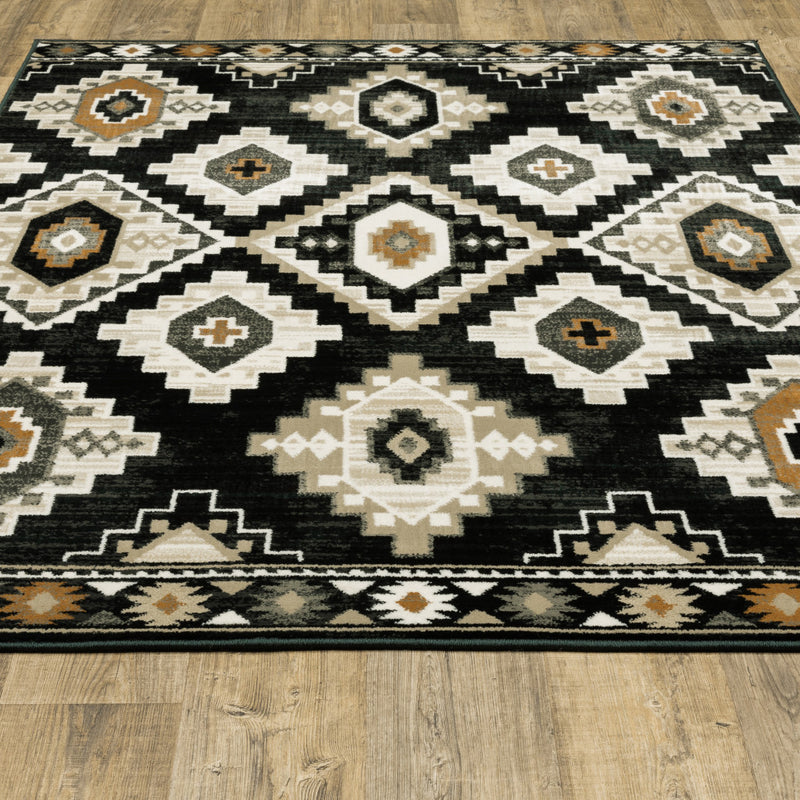 6' X 9' Black Grey Tan Orange And Ivory Southwestern Power Loom Stain Resistant Area Rug